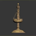 Golden Balance Scales with Green Gemstone on Top and Decorative Metallic Base Against Dark Background