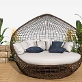 Oval Rattan Outdoor Sofa With White Cushions And Lush Green Plants