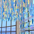 Hanging Art Installation With Colorful Transparent Bubbles Paper Strips Large Windows And Blue Sky