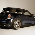Shiny Black Sporty Compact Car With Alloy Wheels And Front Grille Design