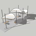Modern Outdoor Structure With Curved White Canopies Black Poles And Ground Stones