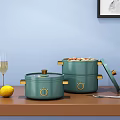 Green Cooking Pots With Golden Accents Open Lid Food Lemon Champagne Glass And Utensils