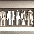Cozy Neutral Robes With Soft Fabric And Belts Hanging In Wardrobe