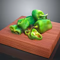 Fresh Whole and Sliced Green Peppers on a Wooden Board