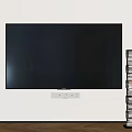 Large Flat Screen TV on White Wall with Stacked Books in Modern Room