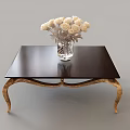 Modern Coffee Table With Black Tabletop Golden Legs And White Flowers In Glass Vase