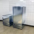 Commercial Kitchen Featuring Two Stainless Steel Refrigerators White Tiled Walls And Beige Flooring