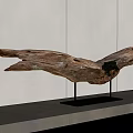 Wooden Eagle Sculpture With Spread Wings On Black Metal Stand Against Gray Wall