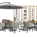 Outdoor Table Set With Woven Chairs Umbrella And Chinese Calligraphy Scrolls