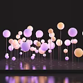 Art Installation Featuring Colorful Spheres on Thin Poles with Black Base and Light Effects