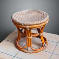Handcrafted Rattan Stool With Round Woven Seat And Sturdy Curved Legs On Tile Floor