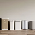 Different Colored Modern Trash Bins Arranged On Wooden Floor With Light Wall
