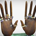 Colorful Gemstone Jewelry Rings Displayed On Wooden Hand Models With Green Base