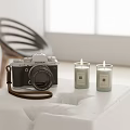 Fujifilm Digital Camera Display With Two Lit Candles On White Table Top