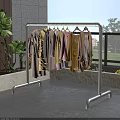 Metal Garment Rack With Colorful Clothes Hanging On Balcony With Green Plants