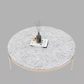 Modern Round Coffee Table With White Speckled Surface Gold Metal Legs And Diffuser On Top