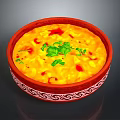 Delicious Yellow Creamy Dish in Red Patterned Bowl with Fresh Green Cilantro and Red Garnish