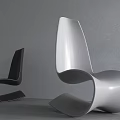 Modern Sleek Design Chair With Curved Shape Against Gray Wall And Floor Lamp