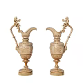 Pair of Ornate Golden Decorative Pitchers With Intricate Carvings And Sculpted Handles