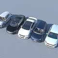 Multiple Different Colored Cars Parked Side by Side on Gray Pavement