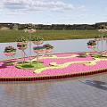 Garden Landscape with Circular Pink Flower Area Multi tiered Stands Near Water and Distant Grassland