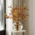 Transparent Glass Vase With Golden And Brown Foliage On White Pedestal