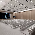 Modern Spacious Conference Room Interior With Rows Of Chairs And Large Projection Screen
