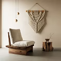 Wooden Frame Lounge Chair With Light Cushion And Macramé Wall Hanging By Wooden Stump Table