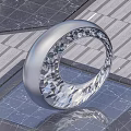 Silver Ring Shaped Sculpture With Diamond Cut Polygonal Structure On Reflective Platform Gray Background