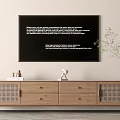 Wooden TV Stand With Drawers Woven Panels Decorations Books Potted Plant And Black Wall Frame