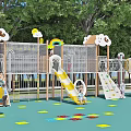 Vibrant Kindergarten Playground With Slide Rainbow Cloud Decorations Colorful Floor And Children Playing