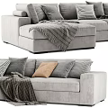 Modern Gray Sectional Sofa Featuring Plush Pillows And Cozy Blankets For Comfortable Seating 3d model