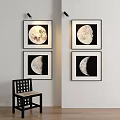 Abstract Moon Phase Paintings with Black Frames on White Wall