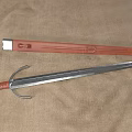 Medieval Sword With Leather Hilt Silver Metal Blade And Leather Scabbard On Beige Fabric Background
