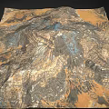Desolate Rocky Mountain Landscape With Layered Terrain Gullies And Multicolored Hues In Brown Orange Blue
