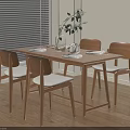 Minimalist Wooden Dining Table Set With Four Upholstered Chairs And Green Plant