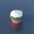 White Frosted Cupcake In Green And Pink Paper Wrapper On Dark Blue Surface With Reflection
