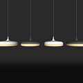 Four Modern White And Black Pendant Lights Hanging Illuminated On Dark Background