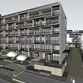 Modern Apartment Building Exterior With Balconies Cherry Blossom Trees And Blue Sky