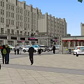 Bustling Commercial Street With Pedestrians Vehicles And Classic Building Facades