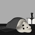 Gray Lazy Sofa With Blanket Next to Small Table Silver Sculptures Open Book Dark Floor