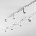 Modern Downlights And Spotlights On Black And White Ceiling Mounted Track With Golden Lamp Heads