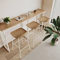 Bar Counter With Wooden Top White Legs Three Bar Stools And Green Plant By Window