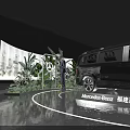 Black MPV Car Showcase On Circular Platform With Green Plants And Screens