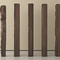Five Different Shaped Wooden Columns Against Light Colored Wall And Gray Floor