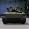 Green Military Tracked Armored Vehicle With Turret Cannon In Indoor Hangar