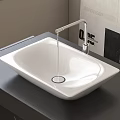 White Rectangular Vessel Sink with White Faucet on Black Countertop and Wall Art