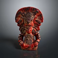 Traditional Red Deity Sculpture With Intricate Carvings And Detailed Headdress On Dark Background