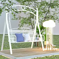 White Metal Frame Swing Chair In Garden With Blue White Cushions And Floor Lamp