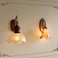 Vintage Wall Sconces With Textured Glass Shades And Ornate Wall Frame Design